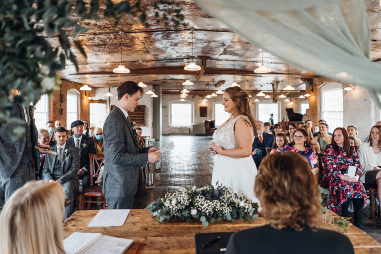 Groom saying vows to bride during ceremony at The West Mill Derby