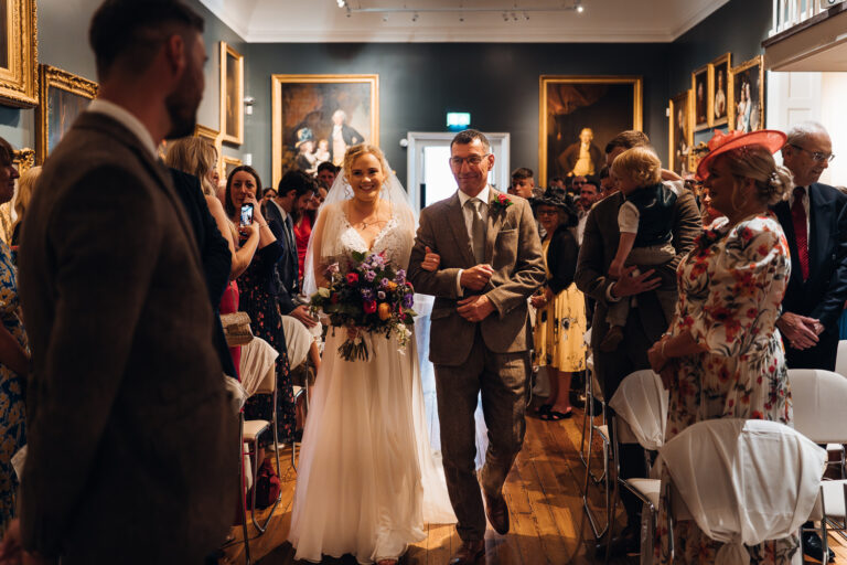Bride being walked down the aisle at Derby Museum & Art Gallery