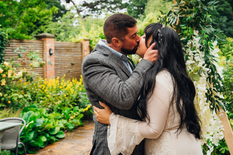 Newlywed couple kissing during their elopement ceremony at The Coach House, Derby